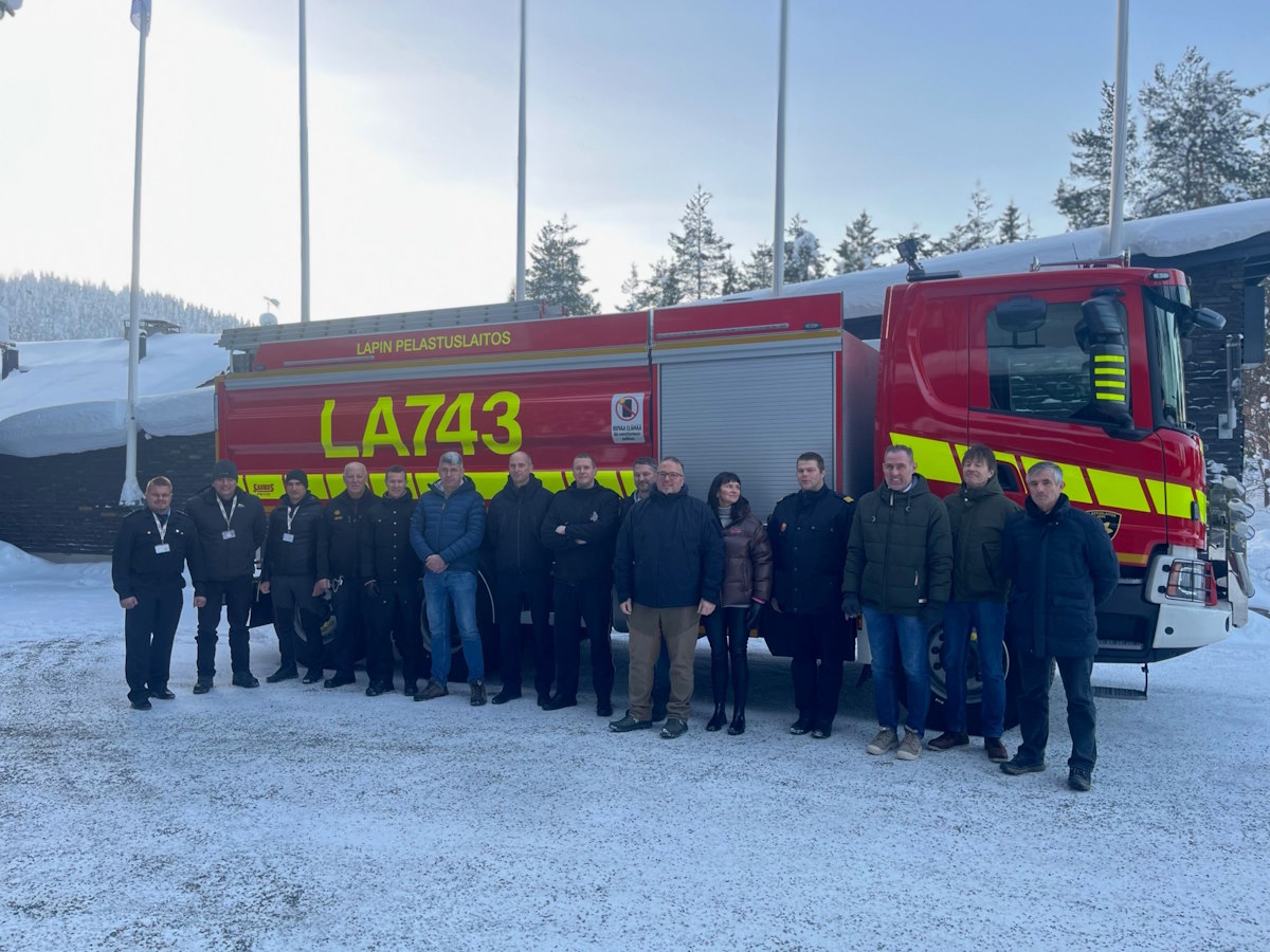 Uudet teknologiat - komissio poseeraa paloauton edessä talvella.